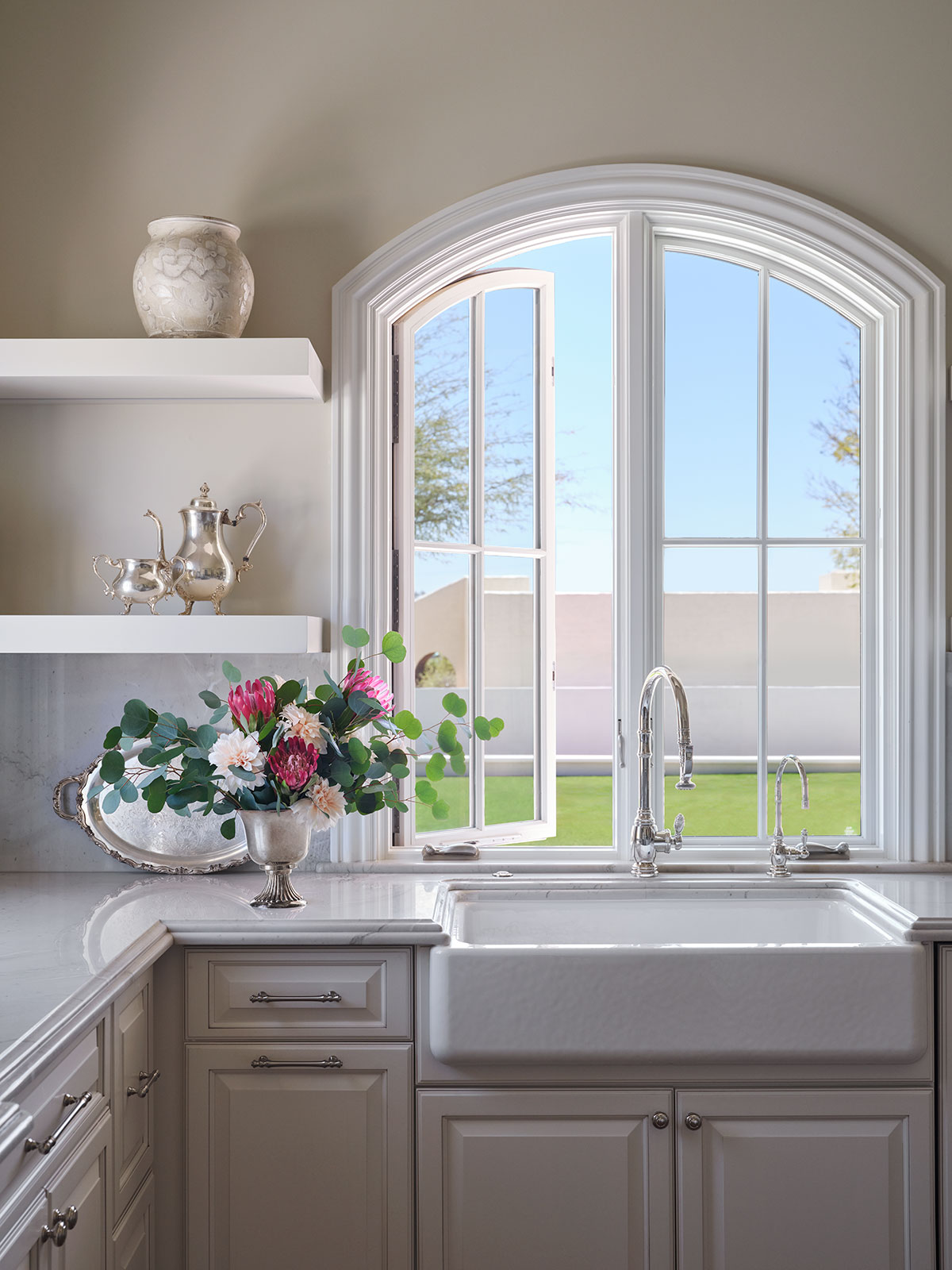 Arched casement window above kitchen sink